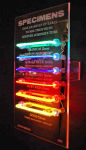<b>Specimens by Anne Ashley</b>, 2009<br>Rare luminous tubes, electrical components, Pyrex, 30x18 inches<br>$2600